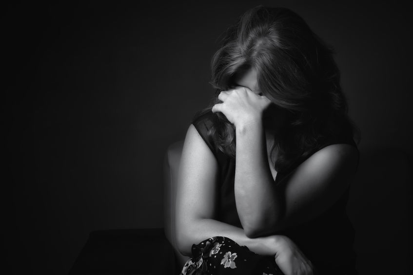 black and white image of a sad woman